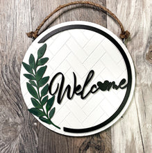 Load image into Gallery viewer, Welcome Home, subtle Fan Art flair Bright crisp white with black and hand painted green leaf Fan Art home decor Fan Art door hanger wall decor.
